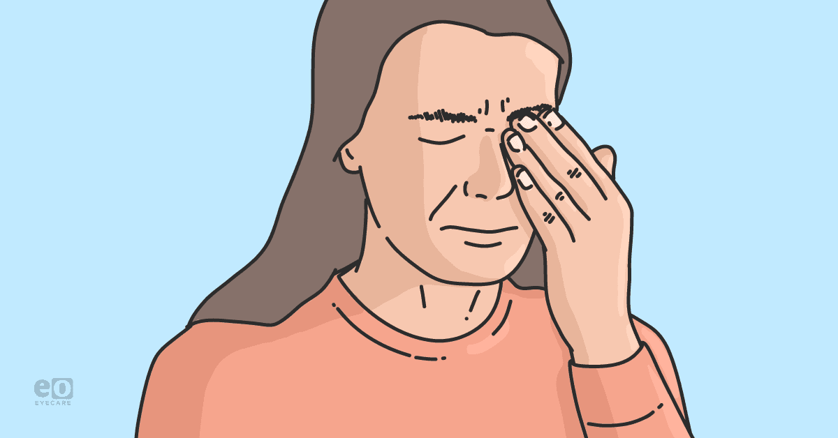 Closeup of a patient rubbing their eye in pain due to transient vision loss.
