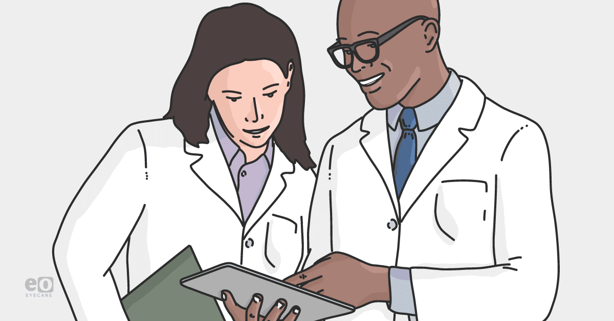 Image of an eyecare practice manager discussing metrics with a staff member to optimize workflows for long-term practice growth.