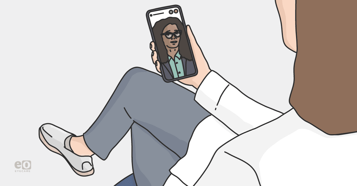 Image of an optometrist in a lab coat performing a telemedicine appointment with a patient.